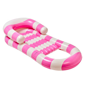 The Laze & Lounge inflatable pool lounger features pink and white stripes, armrests, a reclining backrest, and an inflatable headrest—combining style and comfort for relaxing in the pool.
