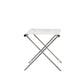 The Sundeck Folding Director's Footrest features a metal frame and white fabric seat, inspired by campaign furniture, and is photographed against a plain white background.
