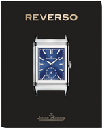 A Jaeger-LeCoultre: Reverso wristwatch with an Art Deco blue dial displayed on a black background. The words "REVERSO" and "Jaeger-LeCoultre" appear above and below the watch, respectively.