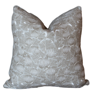 A square, beige Foliage Mushroom Pillow with an intricate white floral pattern and slightly folded corners, made from the finest materials with special attention to detail.