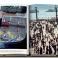 The open book displays two pages: the left page shows a person in a gondola with a gondolier, while the right page depicts a crowded waterfront area alive with people walking and boats in the water, reminiscent of French hospitality akin to Jean Imbert's culinary artistry at Plaza Athenee.