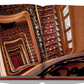 Open book showcasing a photograph of a spiral staircase with ornate railings and patterned walls, viewed from above, reminiscent of the elegance found at Plaza Athenee and the charm of French hospitality.