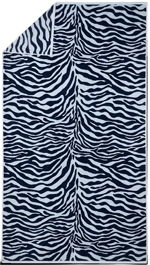 The Matouk Santiago Beach Towel, featuring a chic black and white zebra animal print pattern, is displayed with one corner folded over to reveal its ultra-absorbent terry fabric.