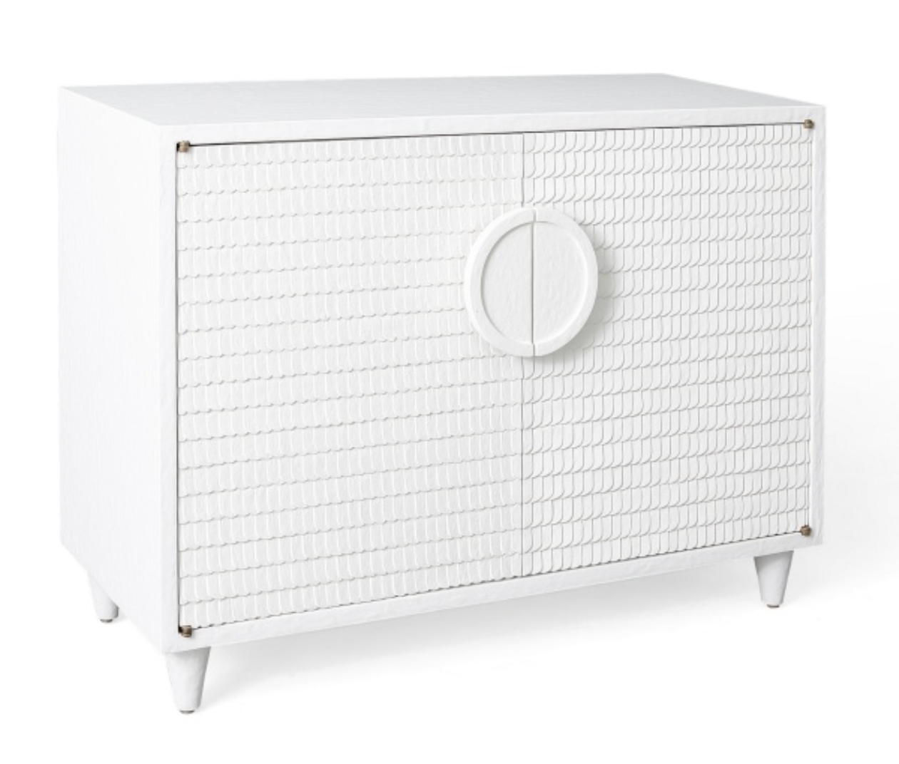 The Lance Cabinet is a hand-crafted, white rectangular piece featuring textured front doors and a circular handle, supported by four tapered legs. Its minimalist design makes it a perfect fit for modern furniture settings.