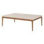 The Sloop Rectangle Cocktail Table in Natural Teak with Bianco Crema Dune brings tropical flair to your coastal living space, featuring a beige top and wooden legs. Shown on a white background.