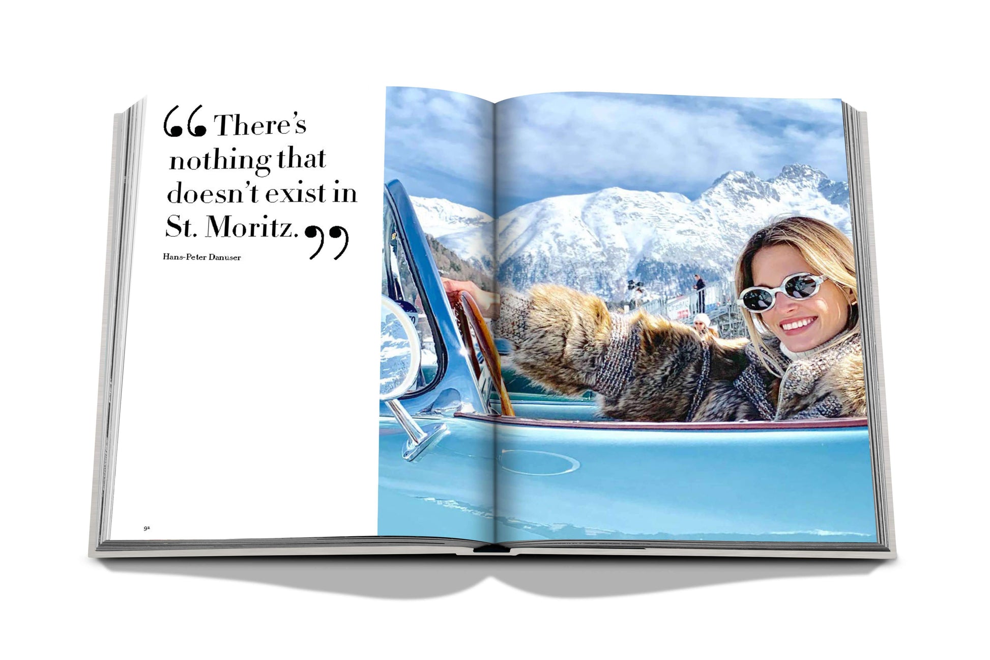 A woman enjoys a sunny day in a luxury convertible with snowy mountains in the background, as featured in a magazine article about the Snow Polo World Cup in St. Moritz Chic by Assouline.