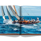 Open book displaying an image of a sailboat with multiple people on board, navigating through blue ocean waters on a sunny day at St Tropez Soleil.