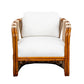 A Strings Attached Lounge Chair with a light-colored cushion and backrest. The chair has a rounded, natural finish frame and woven rattan sides.