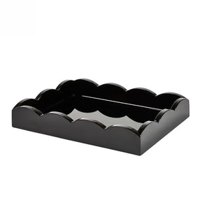The Scalloped Lacquer Tray in Black features scalloped edges and a glossy finish, making it a stylish drinks tray. Shown on a plain white background.