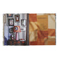 An open book, The World of Peter Dunham: the left page features a stylish interior by designer Peter Dunham with art, lamp, and table; the right shows a contents list on a patchwork fabric background.