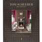 The cover of the book titled "The Tom Scheerer Compendium" features an image of a stylish living room embodying Relaxed Modernism with patterned furniture, a fireplace, and a mirror above it. A stunning example of American interior design, photography by Francesco Lagnese.