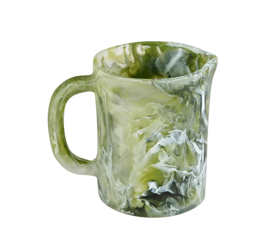 A Nashi Home Serveware Collection, Forest measuring cup in green marbled resinware with handle and spout, perfect as unique home decor or a serving piece. Isolated on white background.