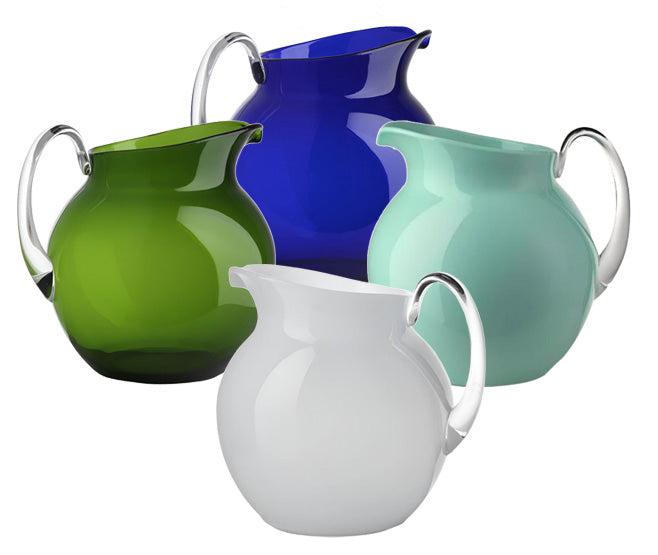 A collection of four Mario Luca Giusti Acrylic Palla Pitchers in green, blue, teal, and white are artfully arranged, showcasing the refreshing new shapes that Mario Luca Giusti is famous for.