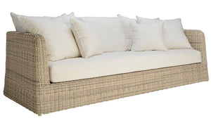 The Zeya Outdoor 3 Seater Sofa features a beige wicker frame, white seat cushion, and five white throw pillows—an ideal choice for creating a welcoming outdoor retreat.
