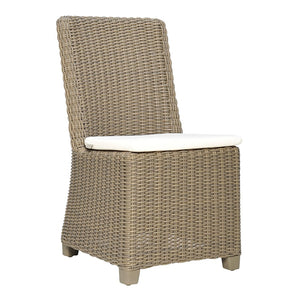 The Zeya Outdoor Dining Side Chair features a weather-resistant wicker design with a high back, short legs, woven pattern, and a white seat cushion—ideal for stylish outdoor dining.