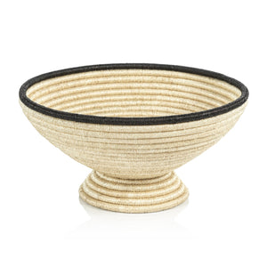 The Zodax Martigues Abaca Bowl Collection features a handwoven, cone-shaped bowl with a textured surface and black rim, showcasing native craftsmanship.