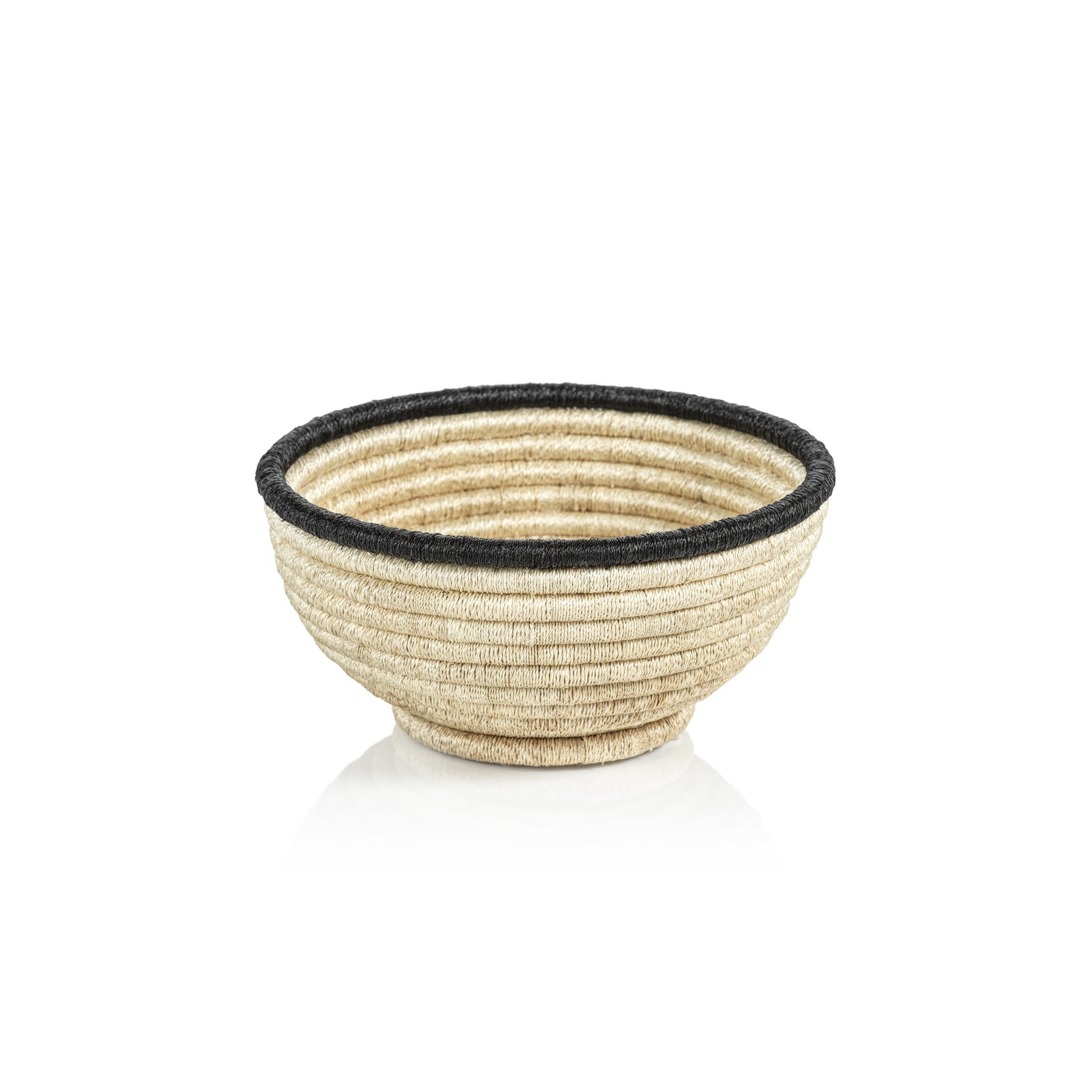 The Zodax Martigues Abaca Bowl Collection features a round, beige woven basket with a black rim, highlighting native craftsmanship on a white background.