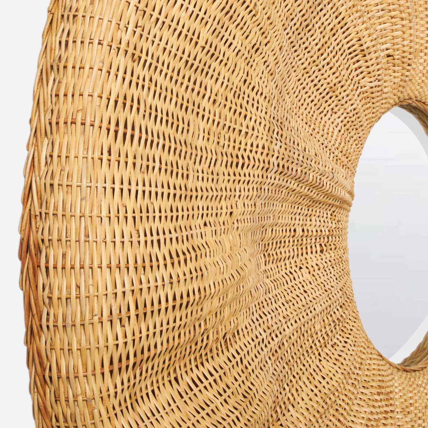 Close-up side view of the Larkin Rattan Mirror featuring a central circular glass and woven rattan frame, set against a white background—an ideal statement wall piece for bohemian-inspired decor.