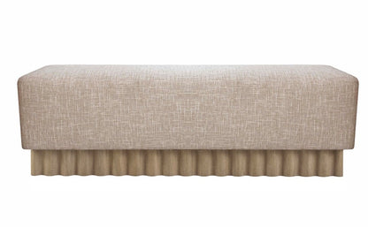 The Aemilius Bench showcases a beige rectangular design with a textured fabric surface and a pleated skirt base, offering an organic style that enhances any modernist aesthetic.