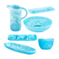 The Nashi Home Serveware Collection, Aqua, features six blue marbled resin pieces—pitcher, bowls, trays, and a sectioned platter—ideal for enhancing home decor. Displayed on a crisp white background.