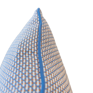 Close-up of the Arles Paon Outdoor Lumbar Pillow, featuring a blue, orange, and white pattern with blue piping, shown from a side angle against a white background. This pillow highlights vibrant colors and expert craftsmanship—an ideal choice for adding a stylish touch to your space.