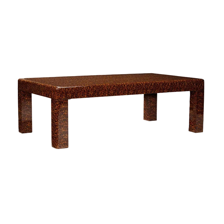 The Bradford Coffee Table has a glossy, textured brown finish like faux tortoise shell and thick straight legs, making it a distinctive addition to your home decor.