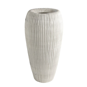 The Baleen Ivory Vase is a tall, cylindrical white Italian ceramic vase with ribbed details, inspired by baleen whales, shown upright against a plain white background.