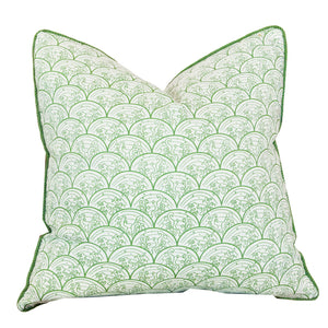 The Wave Grass Pillow, featuring a green and white scalloped pattern with green piped edges, is positioned upright against a plain white background. With a hidden zipper closure for a seamless look, this custom pillow combines style and convenience.