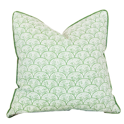 The Wave Grass Pillow, featuring a green and white scalloped pattern with green piped edges, is positioned upright against a plain white background. With a hidden zipper closure for a seamless look, this custom pillow combines style and convenience.