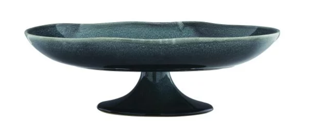 The Laguna Centerpiece is a dark green ceramic pedestal cake stand with a wide, shallow bowl and scalloped edge—an artistic decor piece perfect as a ceramic centerpiece.
