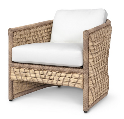 The Capitola Lounge Chair is a square woven rattan chair with a natural-tone frame, white seat and back cushions, and decorative lampakanay rope for added texture.