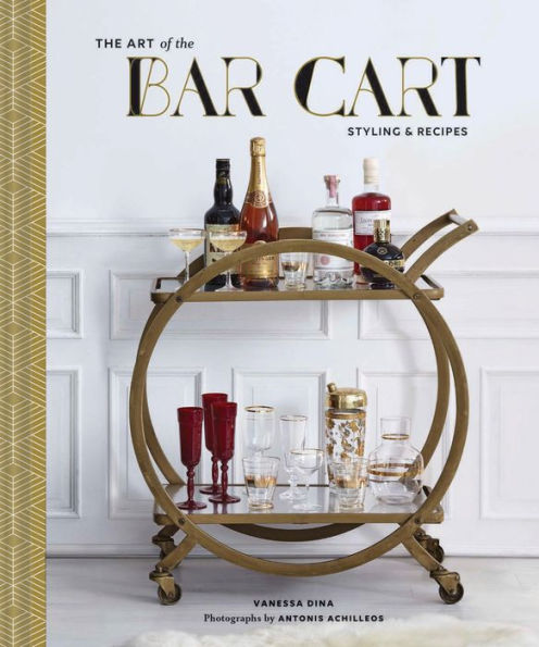 A book titled "Art of the Bar Cart" by Vanessa Dina, featuring styled bar setups with a bar cart stocked with liquor bottles, glassware, and red goblets.