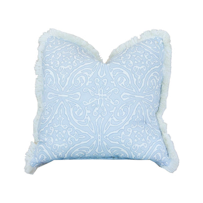 Diamond Batik Blue Pillow featuring white embroidered patterns and fringed edges, designed in a square light blue shape with a hidden zipper closure for a seamless look, displayed against a white background.