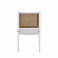 The Bermuda Arm Chair showcases a white frame, cane backrest, and light beige cushion—combining style and comfort for outdoor dining. Displayed from the back against a plain white background.