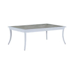 The Bermuda Coffee Table features a light gray rectangular frame, gently curved legs, and a cement-look tabletop with a porcelain inlay—ideal for outdoor use.