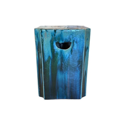 The Turquoise Square Garden Stool features a glossy blue-green finish, cutout front handle, and an antique look inspired by rustic stools made in traditional dragon kilns.