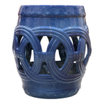 The Dark Blue Circle Garden Stool features a glossy ceramic finish with interwoven circular cutout designs on the sides, offering an antique look inspired by traditional dragon kiln craftsmanship.