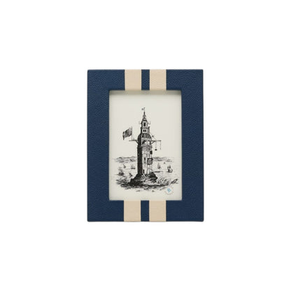 A black and white lighthouse drawing, surrounded by sea and small boats, is displayed in a blue and beige striped frame from the Blake Frame Collection.