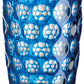 A blue tumbler from the Mario Luca Giusti Lente Acrylic Collection, ideal for outdoor entertaining, featuring a circular, textured pattern.