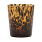 A brown and black speckled tumbler from the Blue Pheasant Andrew Collection features a tortoiseshell pattern on white, showcasing the artistry of hand-blown glassware.