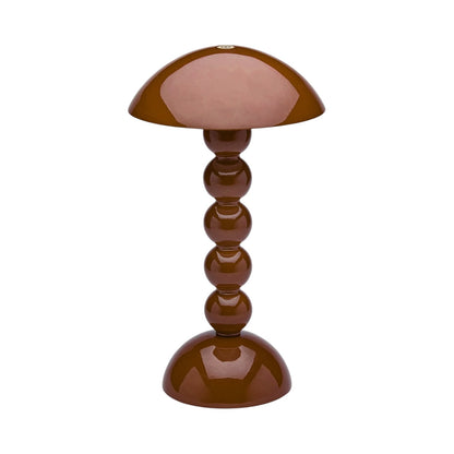 The Addison Ross Bobbin LED Cordless Lamp features a brown, dome-shaped shade and glossy base of stacked spheres, offering portable style and flexibility for any space.