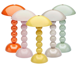Five Addison Ross Bobbin LED Cordless Lamps, each in orange, yellow, white, light pink, and light green, feature dome-shaped shades and rounded bobbin-style bases. Portable and stylish, they are arranged close together.