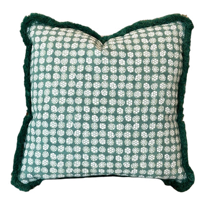 The Boheme Green Outdoor Pillow features a green and white circular pattern, dark green textured edges, and slightly puckered corners, making it a striking luxury accent for any space.