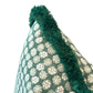 Close-up of the Boheme Green Outdoor Pillow featuring white circular patterns and thick green fringed trim along the edge, expertly crafted for a luxurious touch.