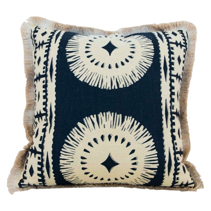 The Bora Bora Lava Black Pillow is a square accent pillow with a black and beige geometric pattern, featuring Polynesian-inspired circular designs and fringe trim along the edges.