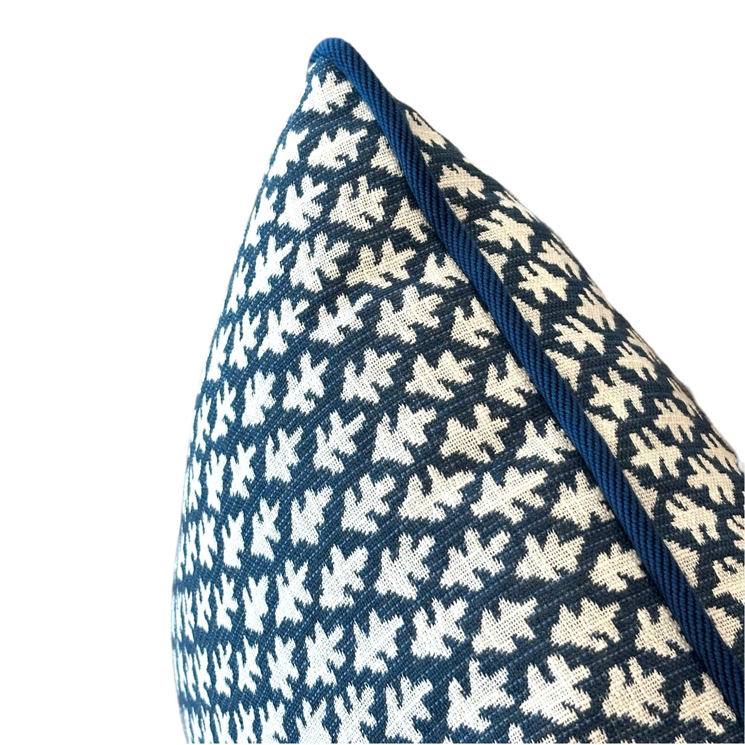 Close-up of the Burma Indigo Outdoor Lumbar Pillow, featuring a blue and white patterned fabric with piped edges, displayed against a plain white background.