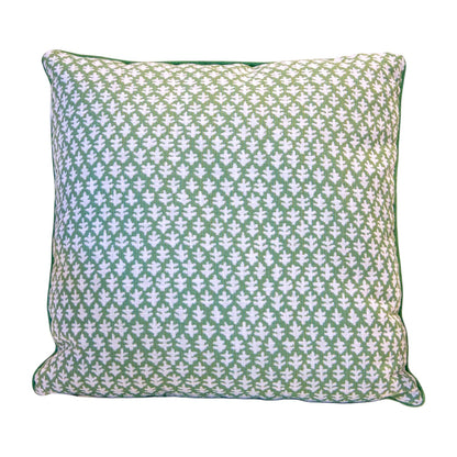 The Burma Meadow Outdoor Pillow is a square green throw pillow with a white repeating leaf pattern, piped edges, and a plain background, crafted for elegance and quality in any space.