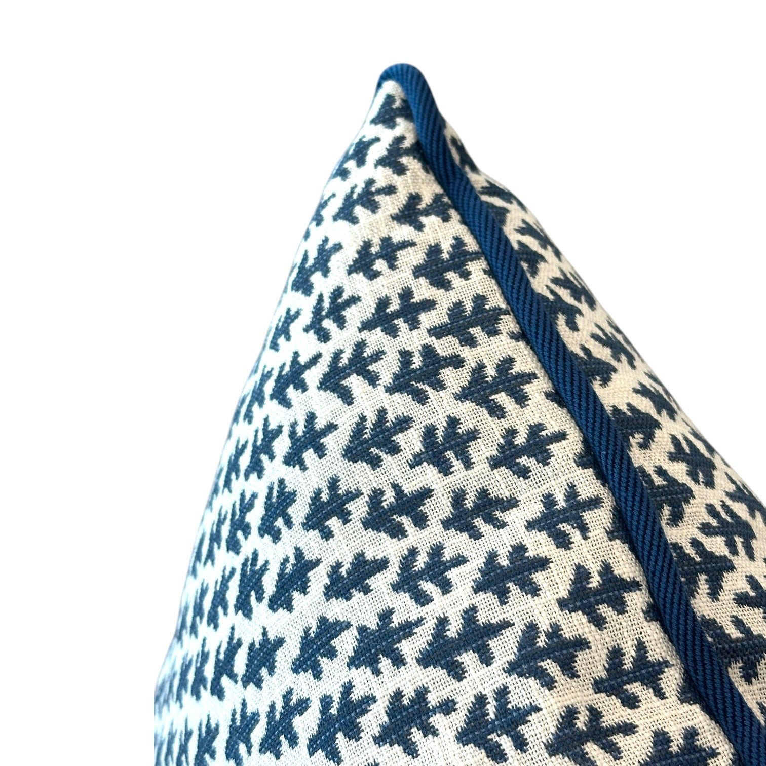 Close-up of the Burma White Indigo Outdoor Pillow, featuring a white base with a blue leaf pattern and blue piping, crafted from premium materials, set against a plain white background.