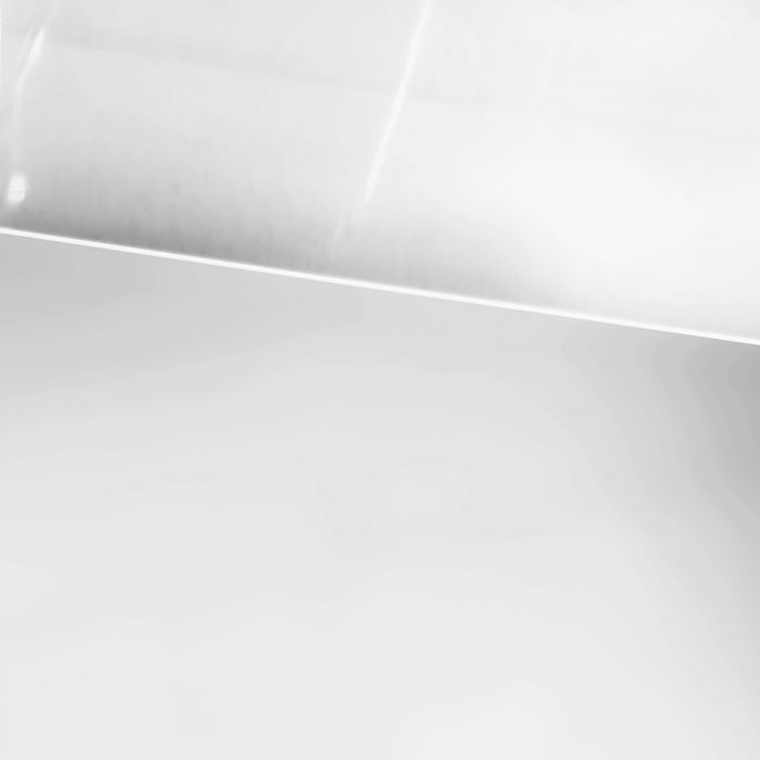 A close-up of a smooth, reflective white surface with a curved edge and light reflections, reminiscent of the signature design details found on the Chelsea Acrylic Console.