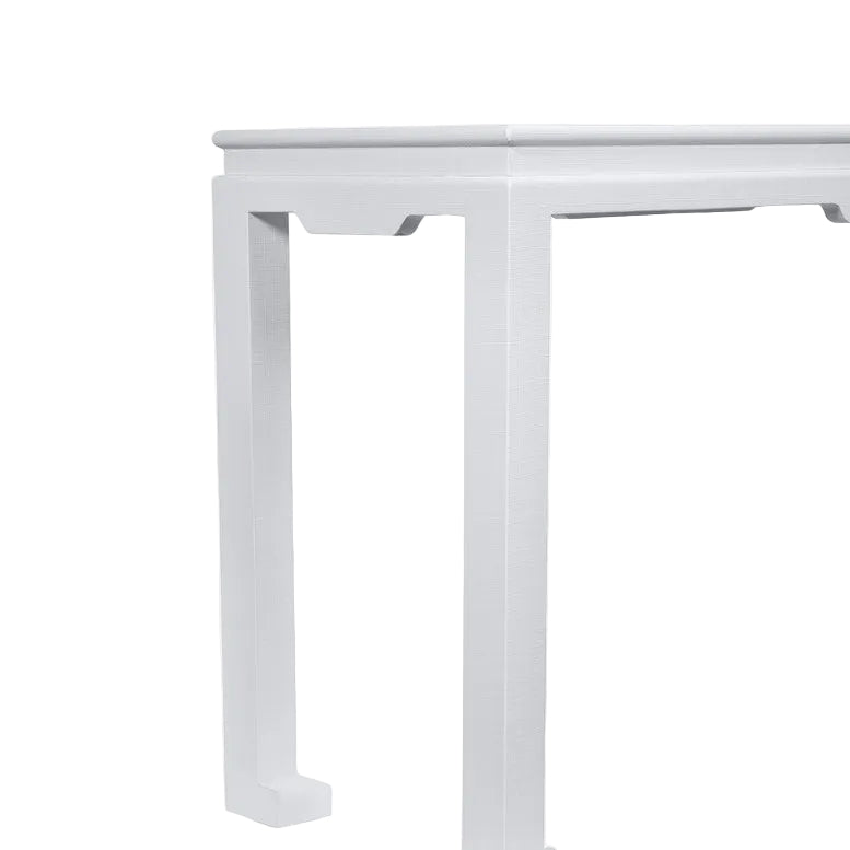 A close-up of the corner of the Wylder Console, a classic white rectangular table with straight legs, set against a plain white background.